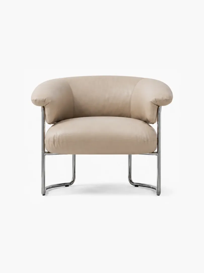 Champagne full grain leather Bauhaus armchair front studio view with horseshoe roll backrest and polished stainless steel sled base