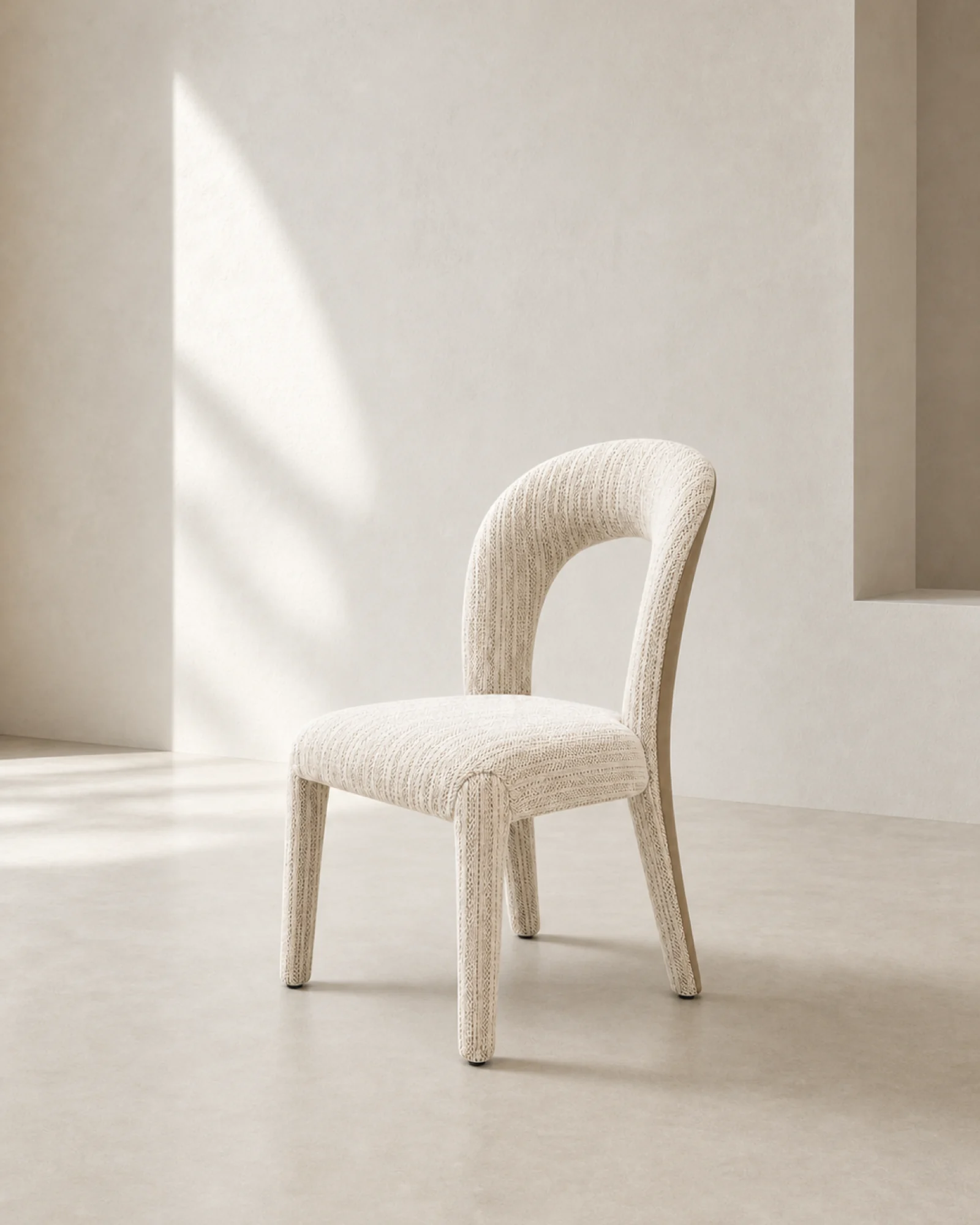 Ivory loop-back dining chair in a restrained mineral dining interior | ROBERT CASA